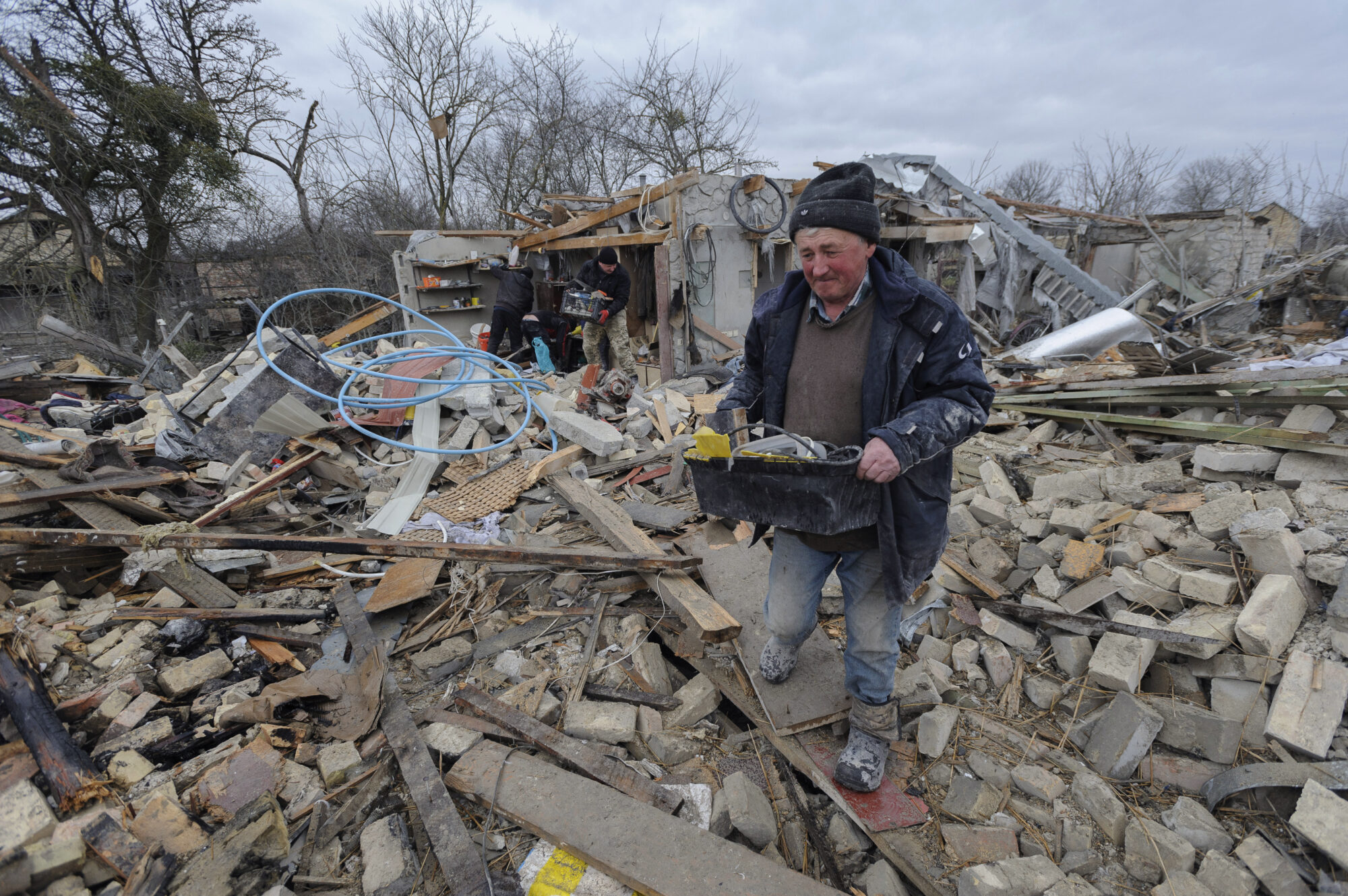 Mann ryddar rundt utbomba hus