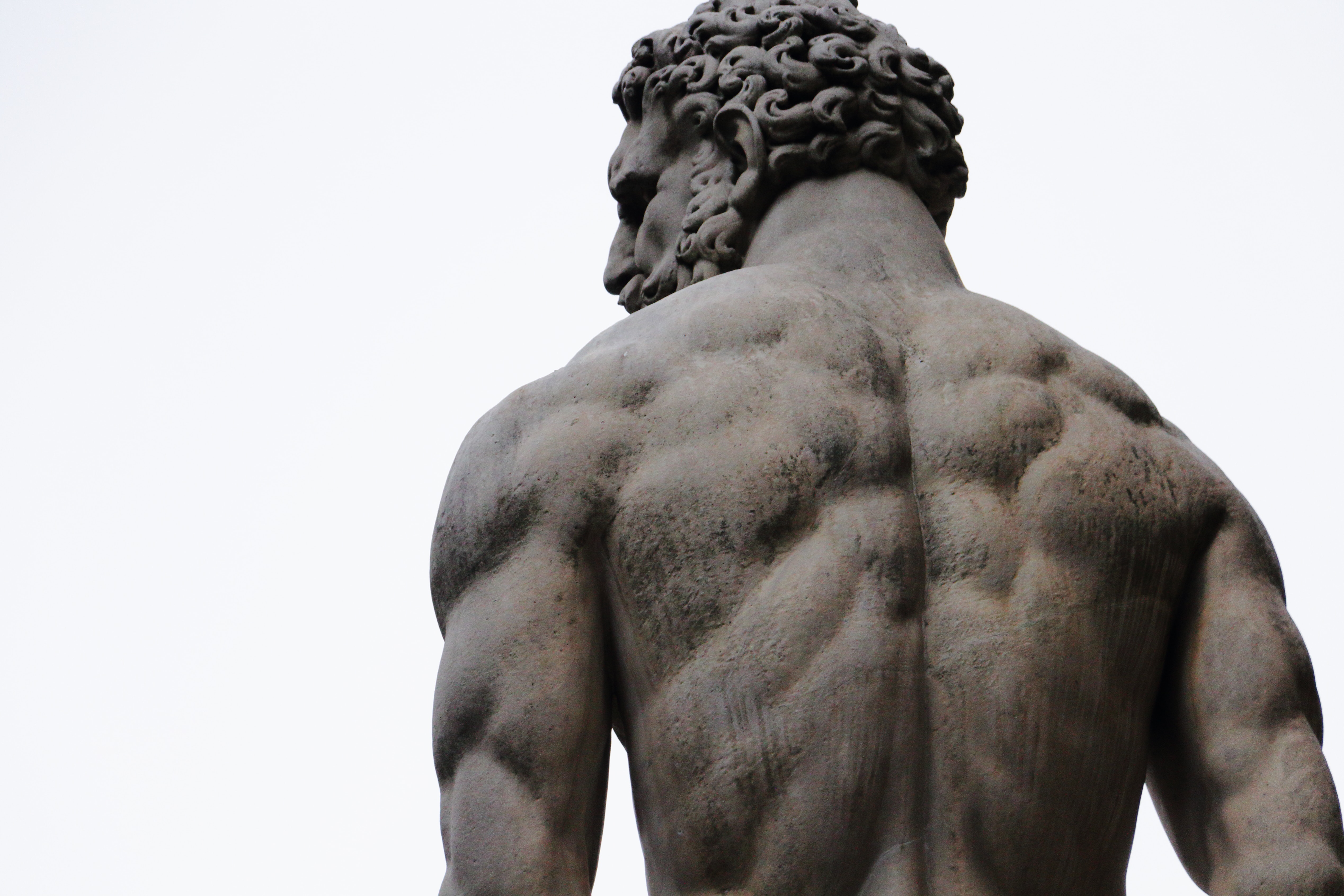Statue av muskuløs mann, bakfra
