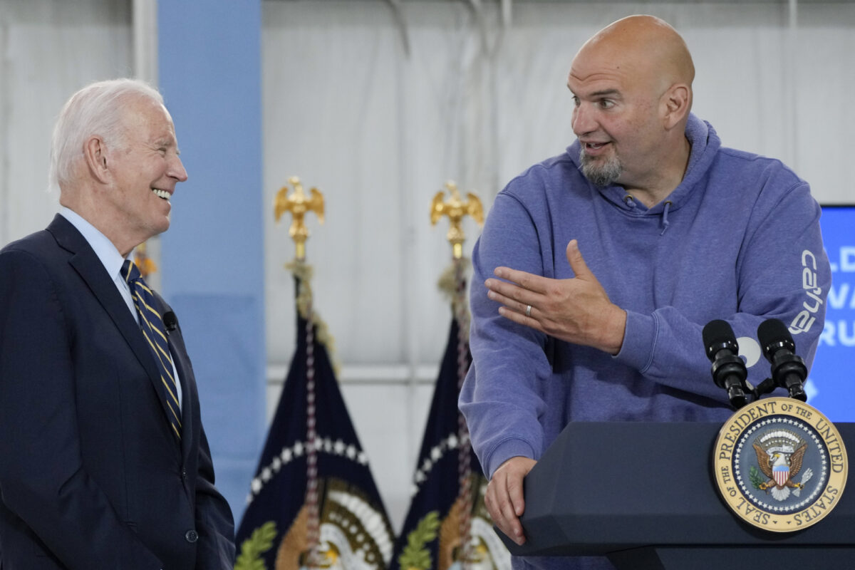 President Joe Biden smiler til ein yngre mann i hettegenser