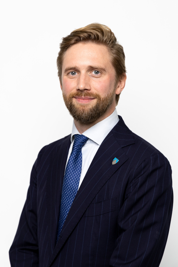 Mann med slips smiler til kameraet